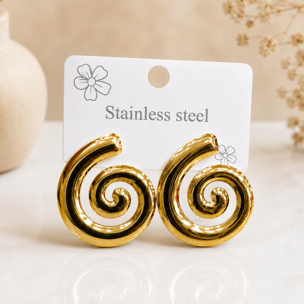 Gold spiral earring worn on ear