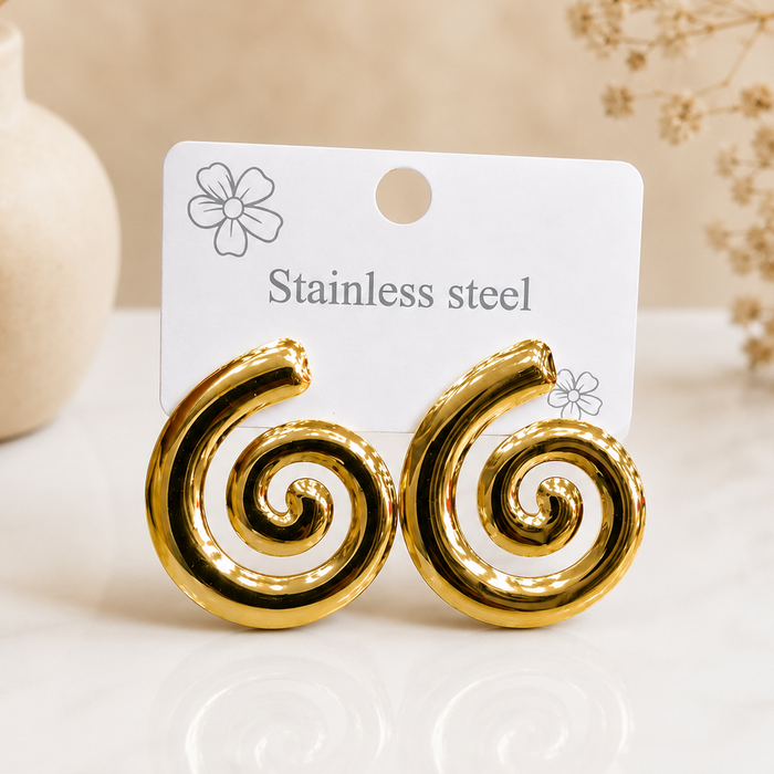 Gold spiral earring worn on ear